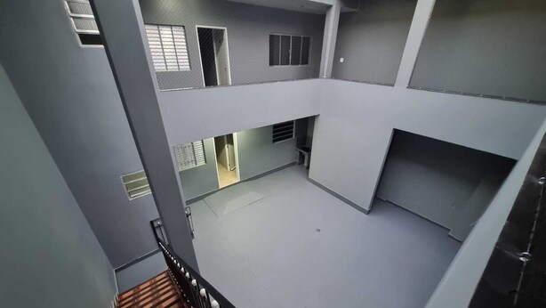 A multi-level building with grey walls and a central open space.