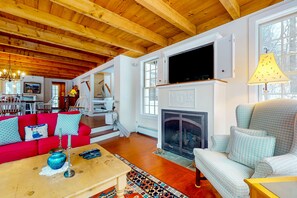 TV, fireplace, books - Picturesque creekside home with gorgeous deck & sunroom, near 4 ski mountains (Dorset)
