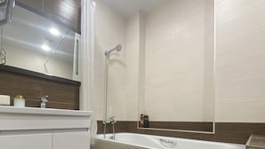 A modern bathroom with a white vanity, a bathtub, and a shower. - Apartment  Home Apart Minsk Zaharova 24 (Minsk)