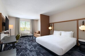 A hotel room with a large bed, a desk with a chair, a TV, and a window with curtains. - Fairfield Inn & Suites Hillsboro (Hillsboro)