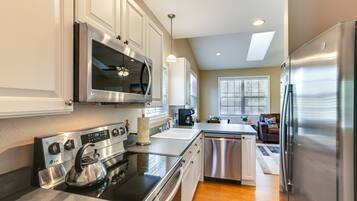 Fridge, dishwasher, coffee/tea maker, cookware/dishes/utensils