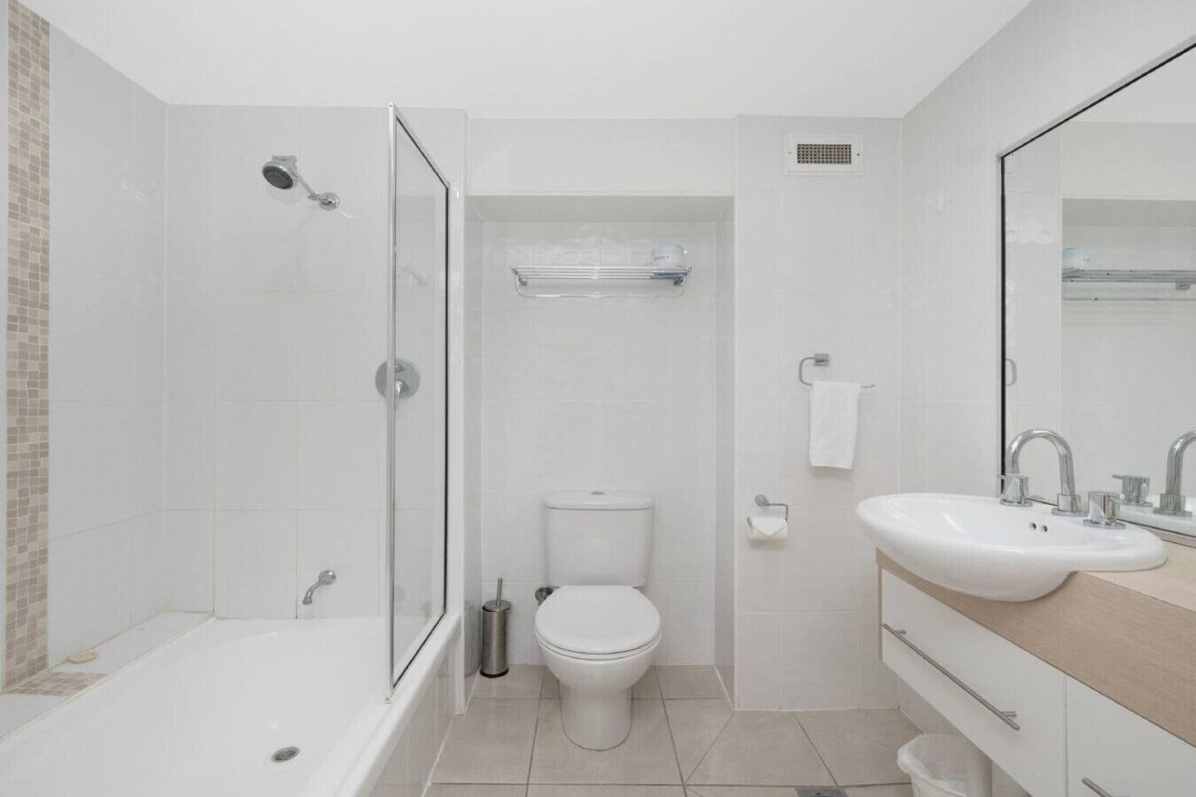 Een moderne badkamer met een bad, toilet en wastafel.
