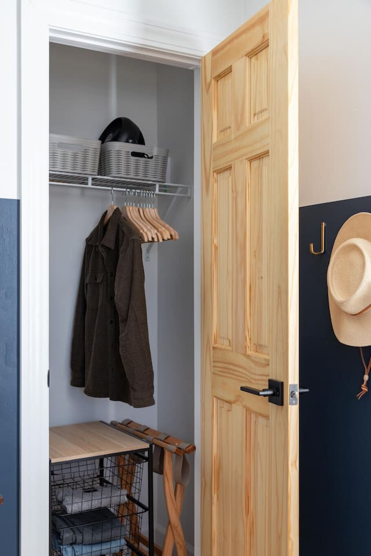 A walk-in closet with shelves, a hanging rack, and a small table.