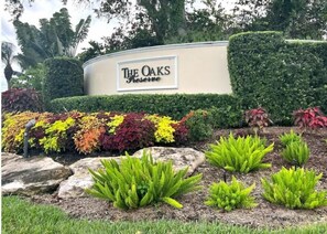 Welcome to The Oaks Preserve, surrounded by lush foliage and beautifully manicured hedges.