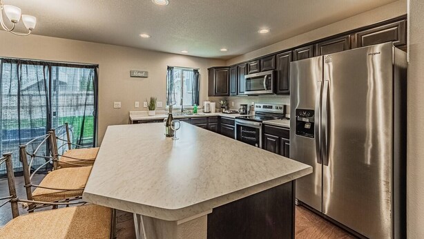 A modern kitchen with a large island, stainless steel appliances, and a view to the outside. - •Lamine Elegance Drive• FreeWine, GameRoom & HotTub (Colorado Springs)