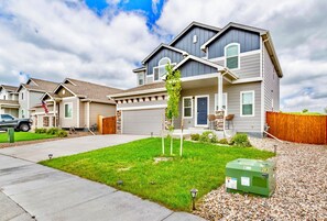 A two-story residential building with a garage, a well-maintained lawn, and a green utility box. - >Wando Best kept Secret< Wine, Hot Tub, Games (Colorado Springs)