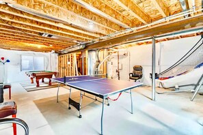 Relax in this spacious room with a ping pong table and pool table, perfect for entertainment.