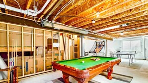 A spacious room with a pool table, a basketball hoop, and a ping pong table. - The Haven @ Justice Wine~HotTub~Game Room (Colorado Springs)