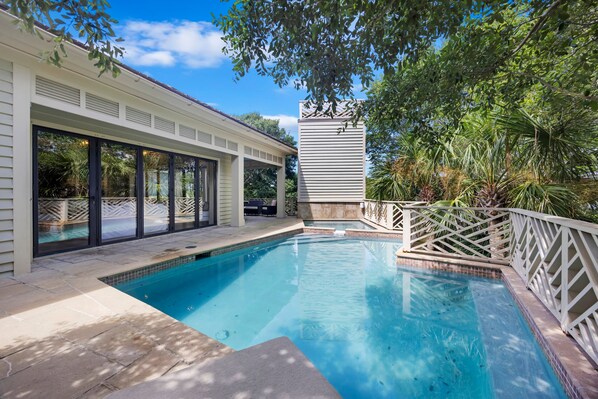 A swimming pool with a white deck, surrounded by a white fence and lush greenery. - IOP Home, Ocean and Intracoastal Views! Private Pool and widow's walk balcony! (Isle Of Palms)