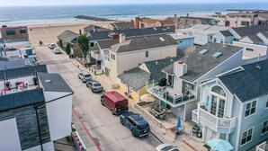 Uma área residencial costeira com casas, uma praia e um trecho de costa rochosa.