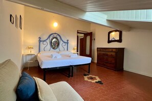 A bedroom with a bed, a dresser, a mirror, and a patterned rug. - GuestHost - Comfortable apartment of approximately 64 m2, able to accommodate up to 4 people, located on the fourth floor of a building without a lift. The accommodation is located in an area full of all services and boasts a wonderful view of the San Te (Lerici)