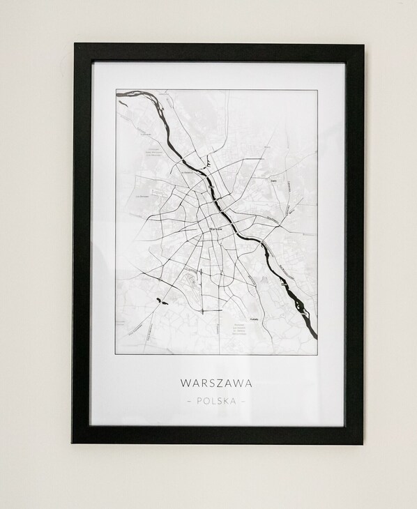 A framed map of Warsaw, Poland, highlighting its road network and major areas.