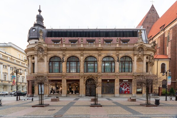 A historic building with ornate architecture, large windows, and a central entrance.