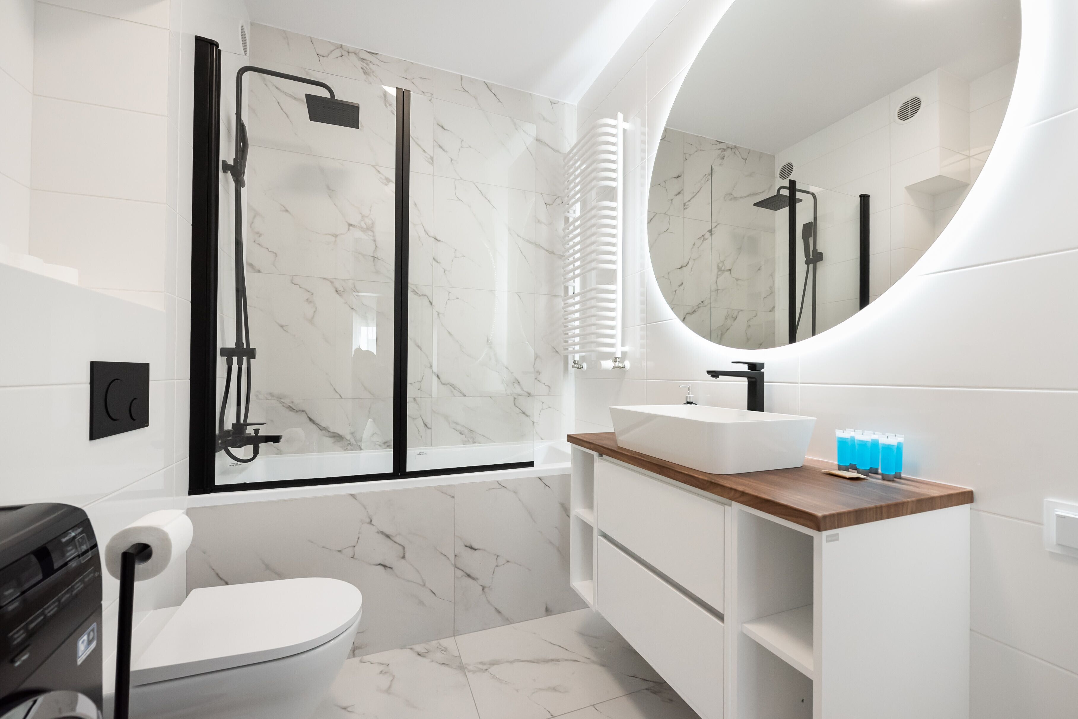 A modern bathroom with a toilet, sink, and shower area.
