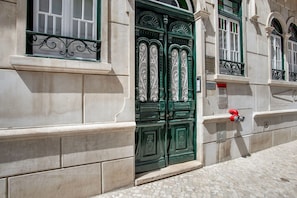 Step through the ornate door into a historic building with traditional charm.