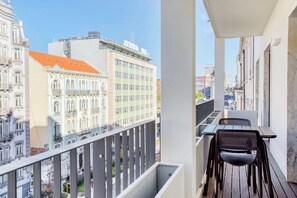 Relax on the balcony with a view of the city's diverse architecture.