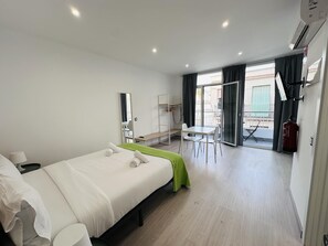 Relax in a spacious room with a large bed, a comfortable reading nook, and a wardrobe for ample storage.