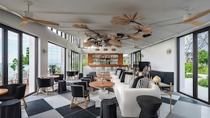 A modern interior with a checkered floor, a bar area, and large windows offering a view of the outdoors. - Khao Lak Marriott Beach Resort and Spa  (Takua Pa)
