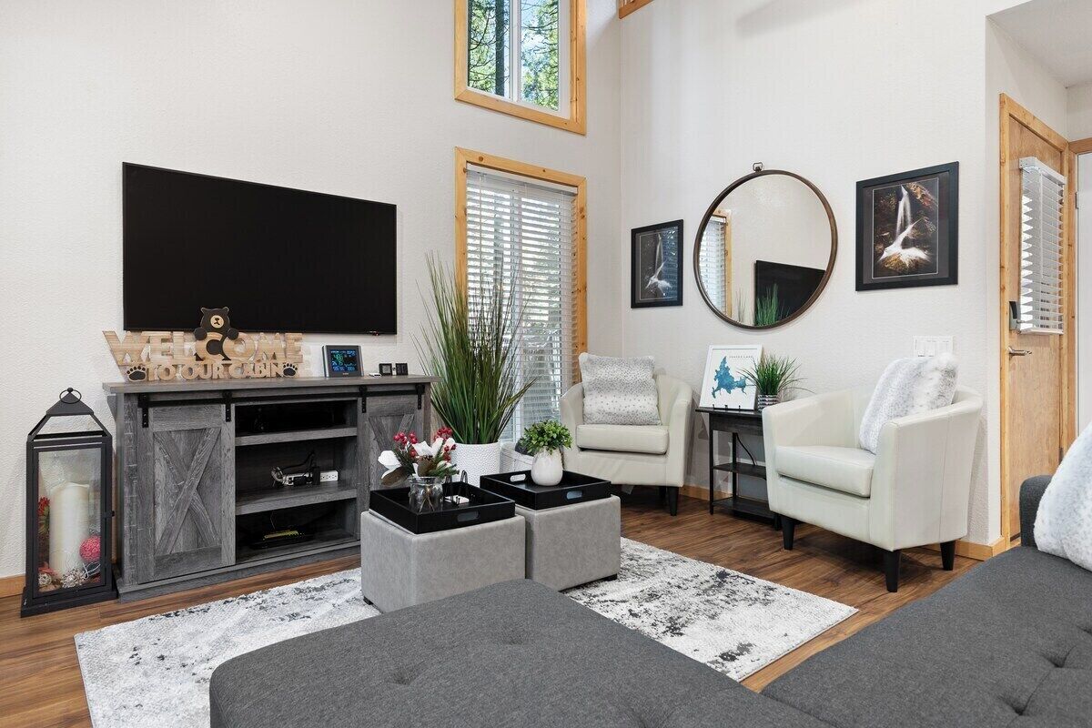 A living room with a flat-screen TV, a fireplace, a sofa, and a coffee table.