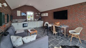 Un espacio habitable compacto con cocina, comedor y zona de estar.