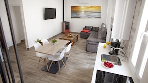 A modern living space with a wooden dining table, white chairs, a grey sofa, a kitchen area with a sink and stove, and a painting of a sunset over the ocean on the wall. - El Palomar, in Algodonales. (Algodonales)