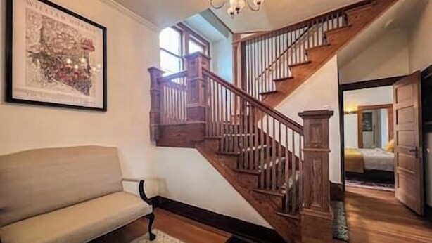 A staircase with wooden railings and a cushioned bench at the bottom. - Family/Pet Friendly Craftsman (Newberg)