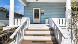 A porch with white railings, a door, and a small window. - Family/Pet Friendly Craftsman (Newberg)