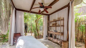 A bedroom with a bed, wooden shelves, and a ceiling fan. - Arthouse Stay with Pool, Gym, & Private Terrace (Tulum)