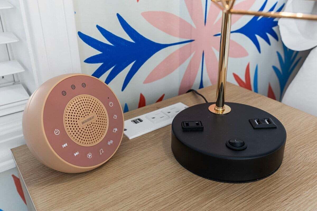 A speaker and a charging station on a wooden surface.