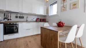 A modern kitchen with white cabinetry, a wooden island, and a red pot. - Italianway - Piranesi 18 B int C 345 - City View (Milan)