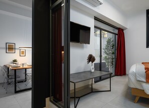 A modern hotel room with a bed, a desk, and a large window. - Sotto Loft (Milan)