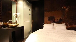 A hotel room with a large bed, a vanity with a bowl sink, and a mirror. - sinchon Y hotel (Seoul)