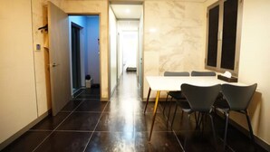 A modern room with a dining table, chairs, and a kitchen area. - sinchon Y hotel (Seoul)