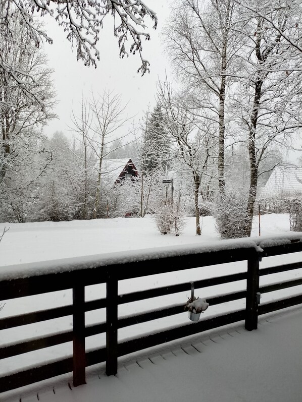 A snow-covered landscape with a wooden fence, trees, and a distant building. - Holiday Home 'Ferienhaus Bergwiese' with Mountain View, Private Garden and Balcony (Siegsdorf)