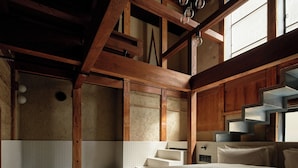 A bedroom with a large bed, wooden beams, a tiled shower area, and a window with natural light. - Kyo no Yado Ishihara (Kyoto)