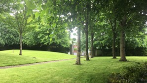 A well-maintained grassy area with trees and a pathway. - Central Spacious 3 Bedroom Apartment With Parking (Dublin)