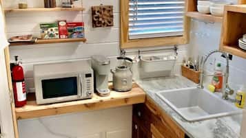 Microwave, stovetop, coffee/tea maker, cookware/dishes/utensils