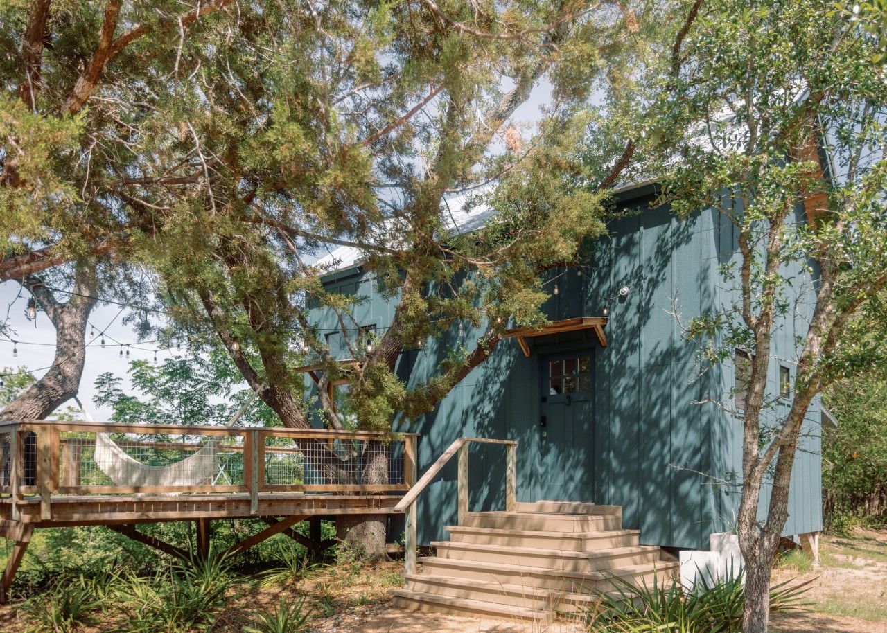 A wooden deck leading to a building with a staircase.