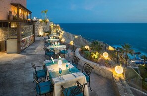 An outdoor dining area with tables and chairs, overlooking a coastal view. - 3BD Hacienda Encantada Stunning Ocean Villa (San José del Cabo)