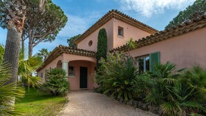 A house with a gravel driveway, a covered entrance, and a garden with various plants. - Vacation home Indigo by Interhome (Grimaud)