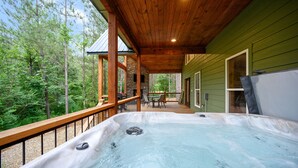 A hot tub on a wooden deck with a view of a forest. - Moonlight Ridge-Loft/Privacy/HotTub (Broken Bow)