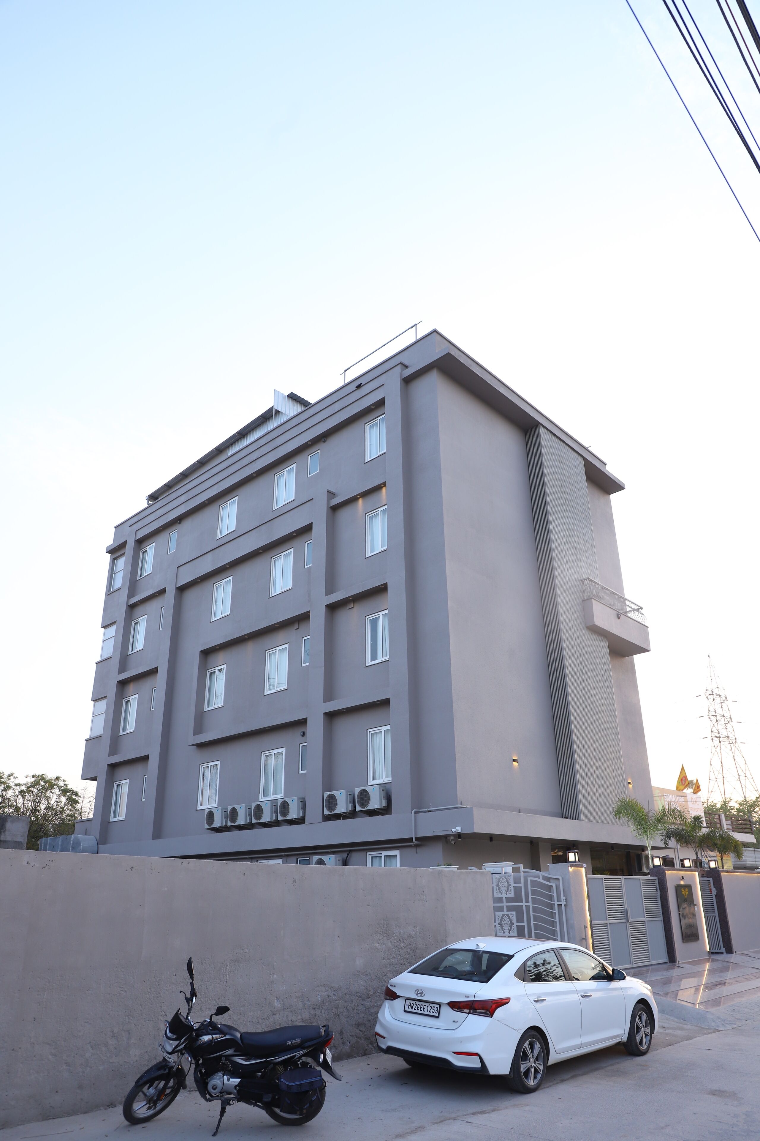 A multi-story building with a modern design, featuring a flat roof and a series of windows on each floor.