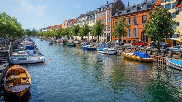 A canal lined with colorful buildings and boats docked along the water.