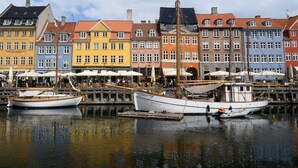 A harbor with colorful buildings and boats docked.