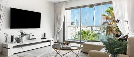 Apartment, Balcony, Sea View | Living area | 65-inch Smart TV with digital channels