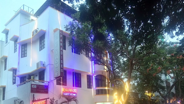 A multi-story building with a sign for 'Paradise Guest House' and 'Meha Paradise'. - Mehaa Paradise Family Guest House (Puducherry)
