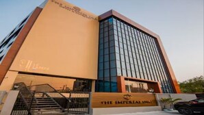 A modern building with a prominent sign reading "The Imperial Inn". - Yashshree Imperial  (Siliguri)