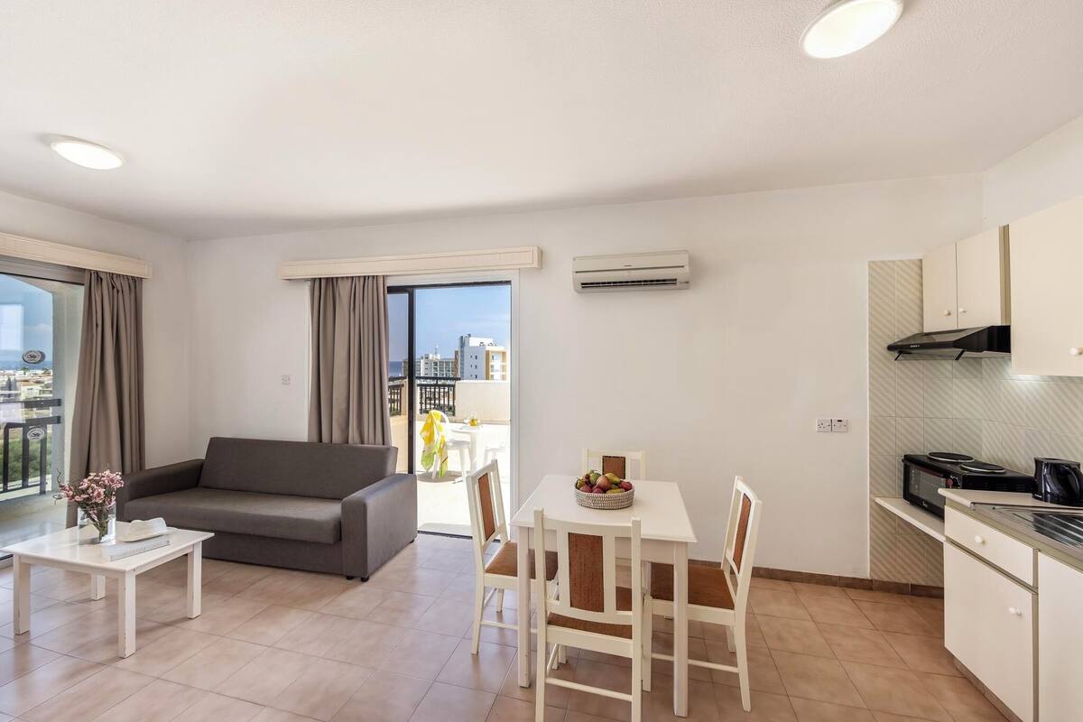 A modern apartment with a living area, dining space, and kitchen.