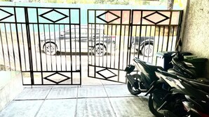 A gated entrance with a motorcycle parked inside. - Morroi Residence Kemang (Jakarta)