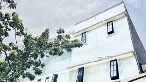 A multi-story building with white walls and multiple windows. - Morroi Residence Kemang (Jakarta)